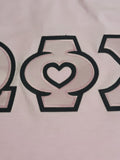 Omega Phi Chi Comfort Colors Rose Quartz T-Shirt with Black on Pink Zigzag Sewn Twill Letters and Heart -